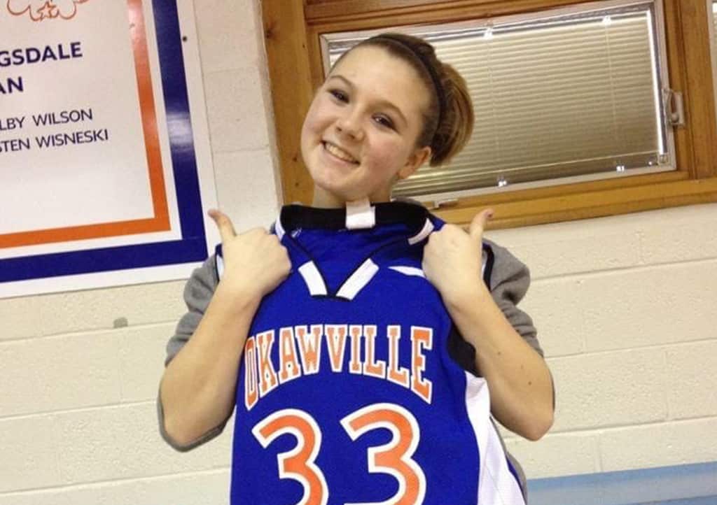Meaghan holding Okawville number 33 basketball jersey