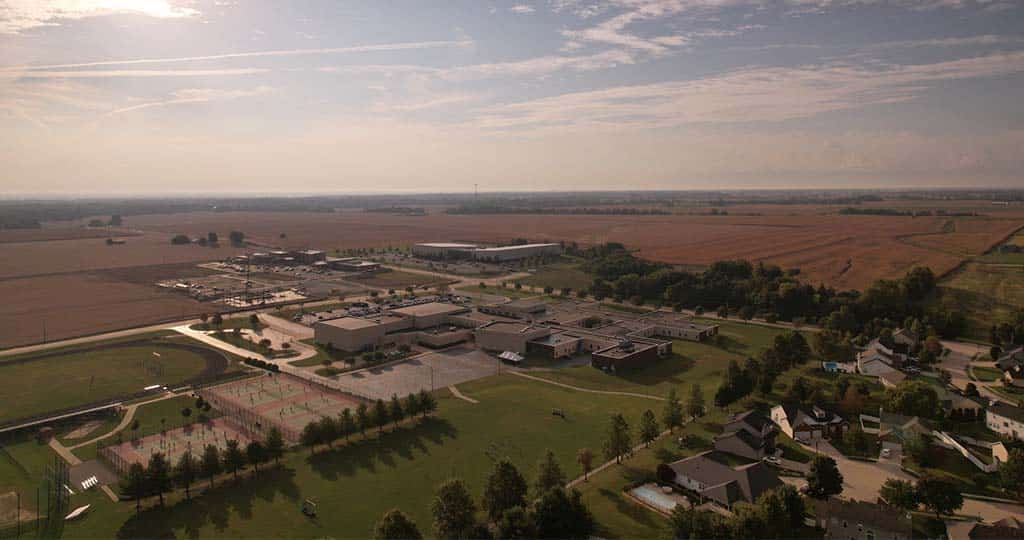 An aerial view of a clinical campus surrounded by homes and fields.