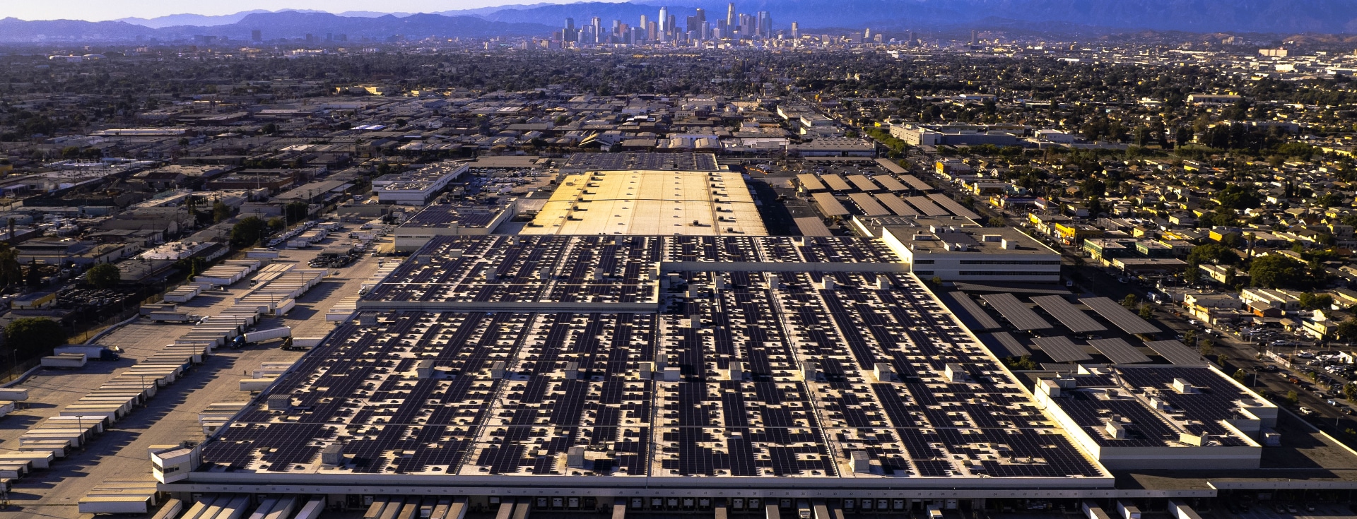 Overhead shot of distribution facility with Los Angeles skyline.
