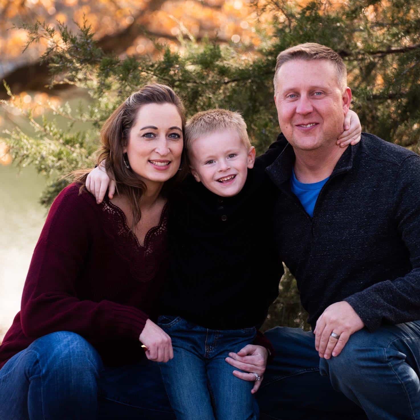 Mindy Keiser, son and husband family portrait outdoors.