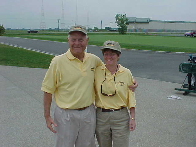 Ralph Korte and adult daughter Susan Bowman wearing matching yellow golf polos.