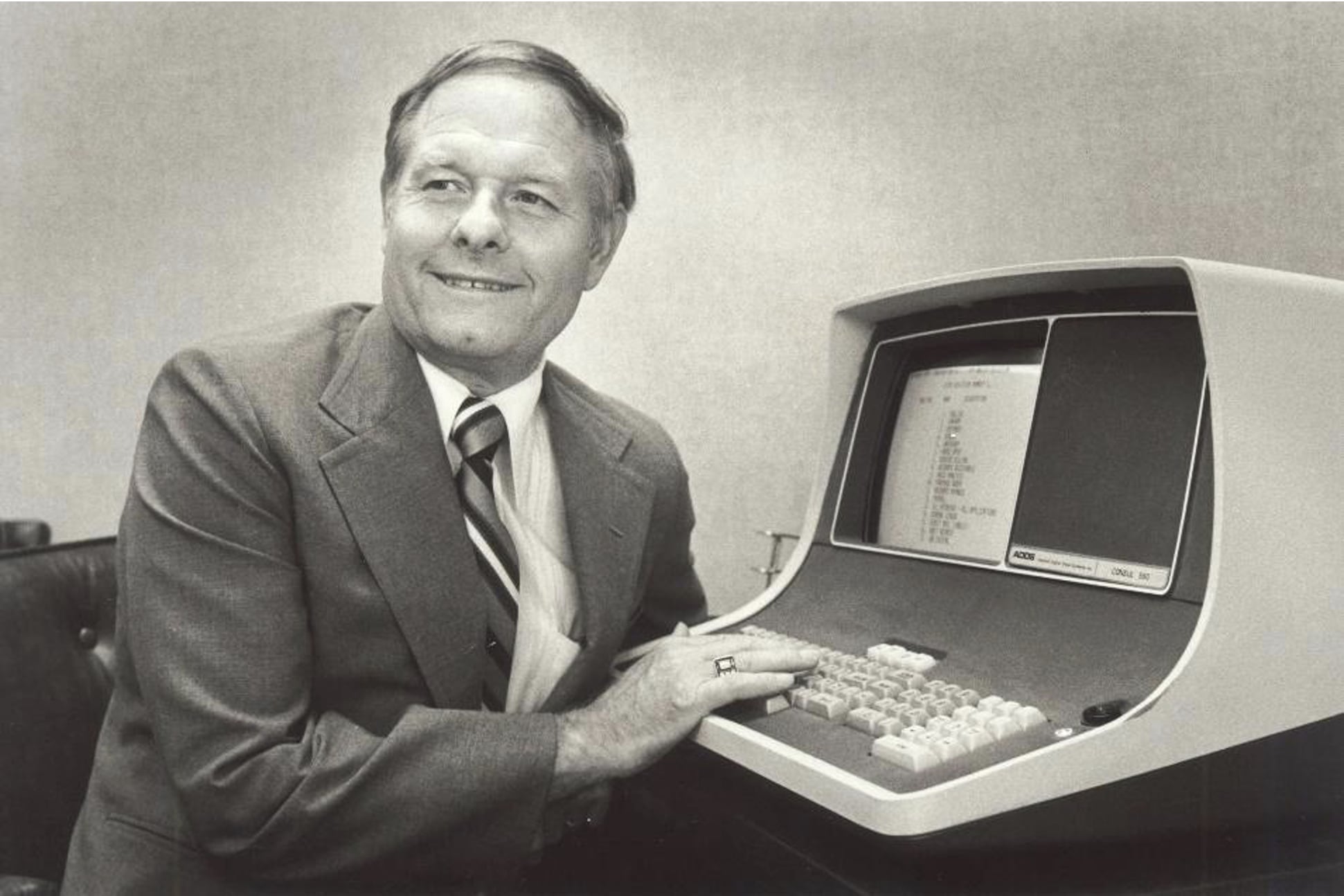 Black and white nostalgia photo of Ralph Korte with the company's first computer.